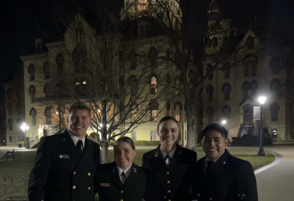 A group of four midshipmen in uniform at the Notre Dame Naval Leadership event