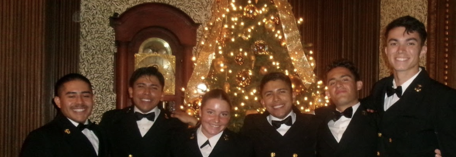 Group of six midshipmen in service dress blues for a dinner event