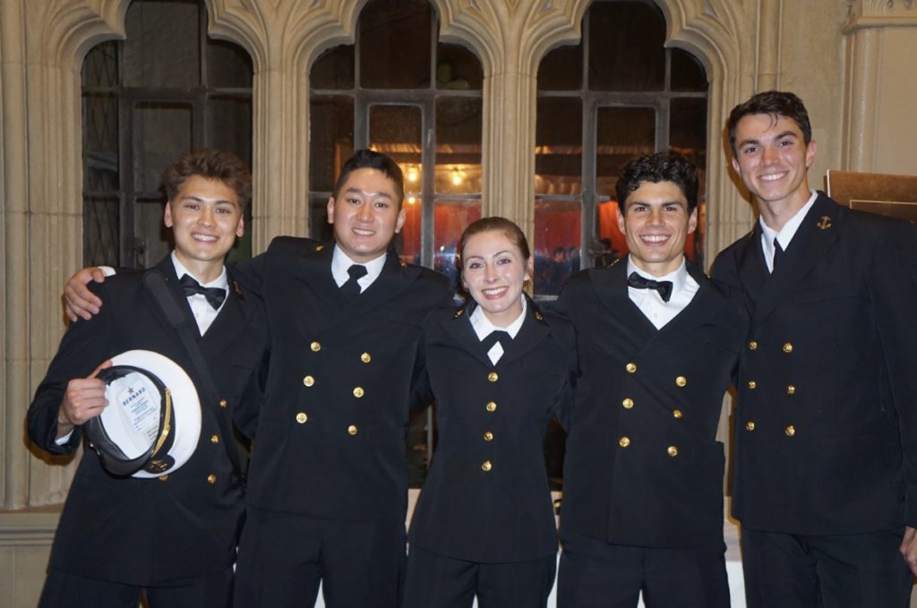 Group of five midshipmen in service dress blues attending the Tri-Service Ball event