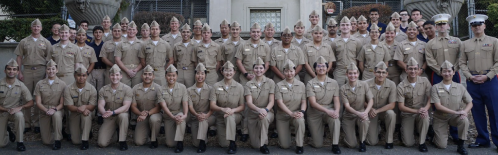 Midshipmen gathered together in military khaki service uniforms